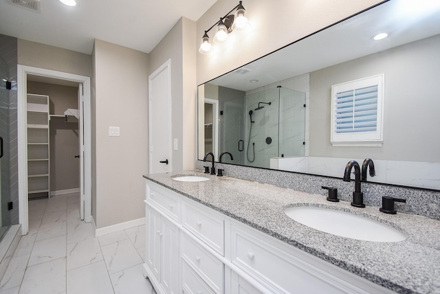 bathroom featuring vanity and a shower with door