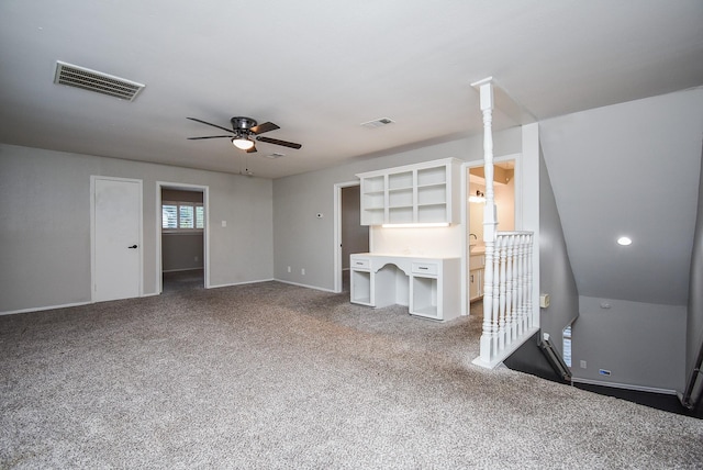 unfurnished living room with carpet, vaulted ceiling, and ceiling fan