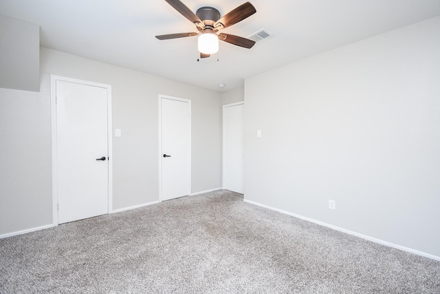 spare room featuring ceiling fan and carpet floors