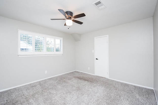 carpeted spare room with ceiling fan