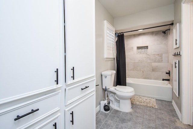 bathroom featuring shower / bath combo and toilet