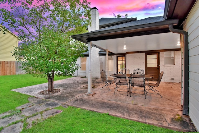 patio terrace at dusk with a lawn