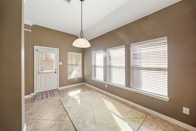 interior space with light tile patterned flooring and lofted ceiling