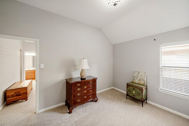 living area featuring lofted ceiling and light colored carpet