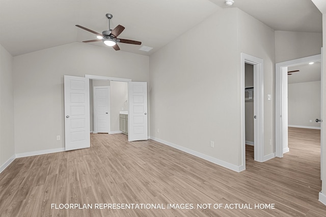 unfurnished bedroom featuring ceiling fan, ensuite bathroom, vaulted ceiling, and light wood-type flooring