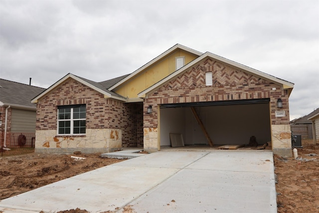 ranch-style home with a garage, brick siding, and concrete driveway