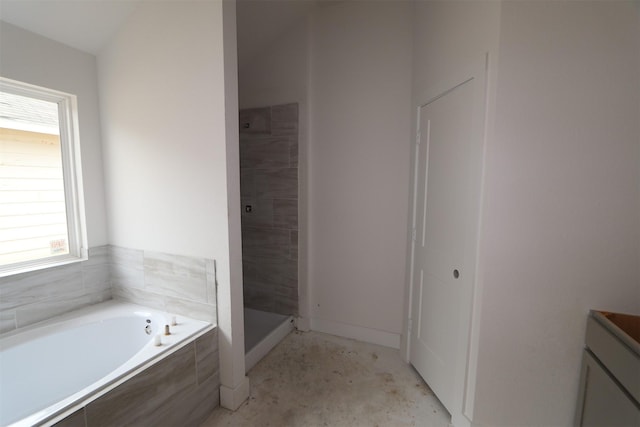 bathroom with vanity, a garden tub, and a shower stall