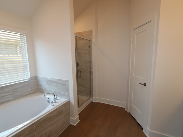 bathroom with a bath, a shower stall, wood finished floors, and a wealth of natural light