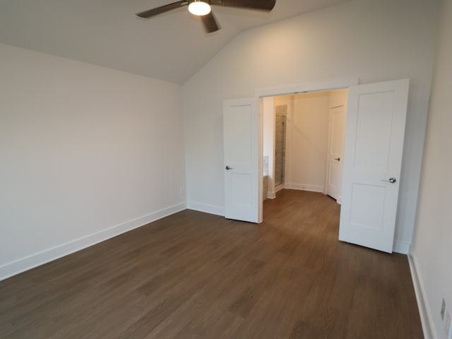 unfurnished bedroom featuring baseboards, a ceiling fan, vaulted ceiling, and dark wood-style floors