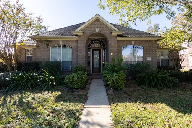 ranch-style house with a front lawn