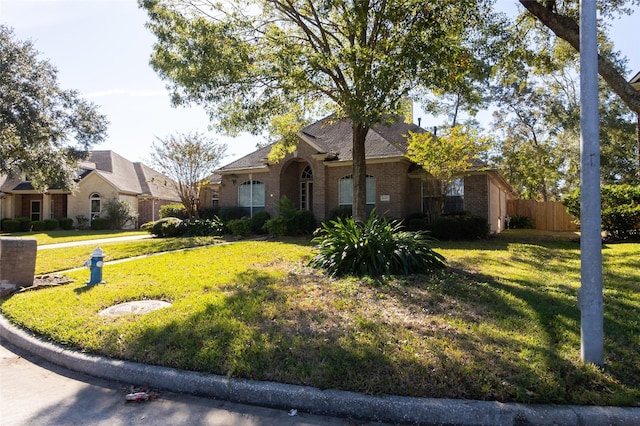 ranch-style home with a front lawn