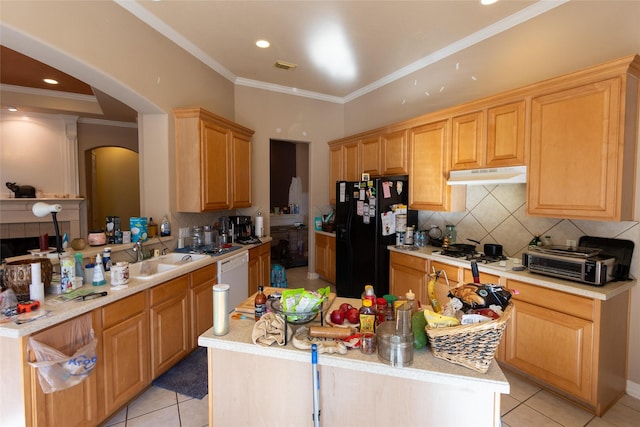 kitchen featuring black refrigerator, crown molding, sink, light tile patterned floors, and kitchen peninsula