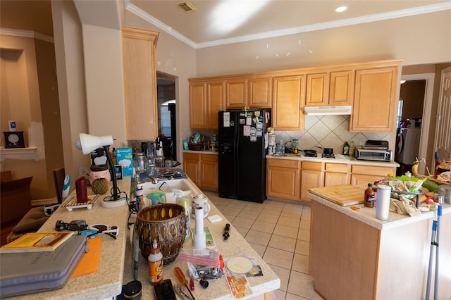 kitchen featuring light brown cabinetry, crown molding, black refrigerator, and light tile patterned flooring