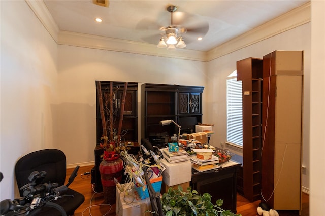 office area featuring ceiling fan, a healthy amount of sunlight, wood-type flooring, and ornamental molding