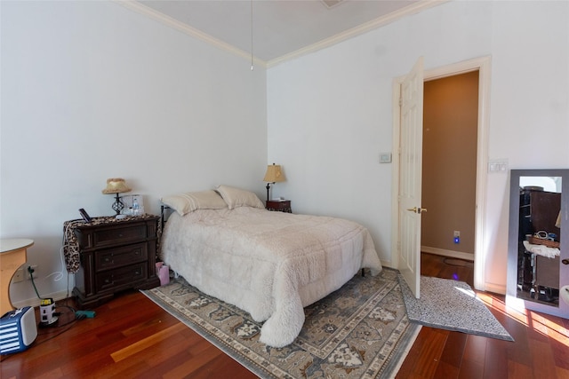 bedroom with crown molding and dark wood-type flooring