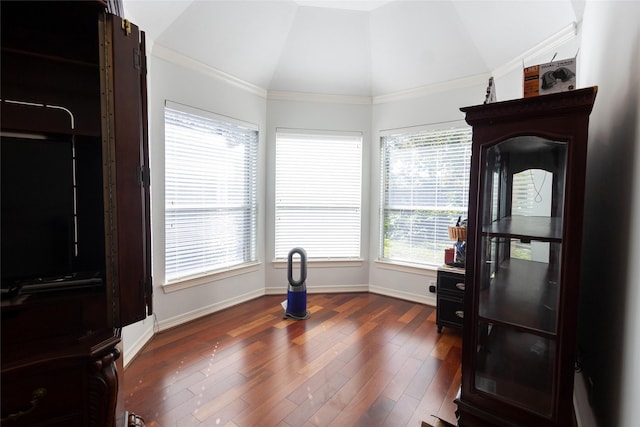 dining space featuring dark hardwood / wood-style flooring, crown molding, and vaulted ceiling