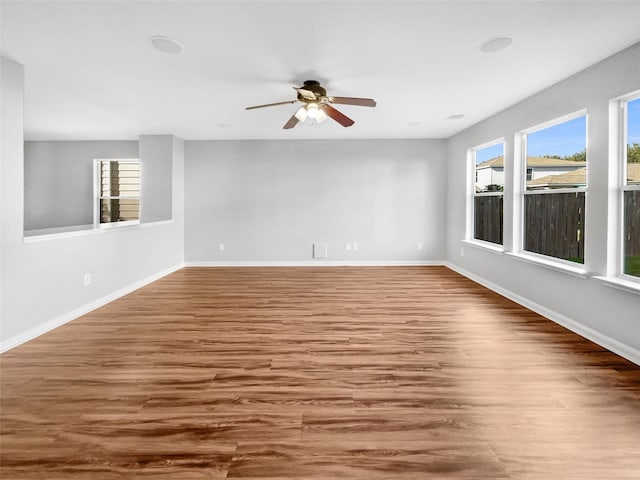 spare room with ceiling fan and hardwood / wood-style flooring