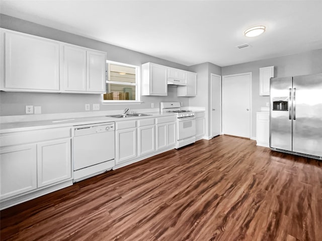 kitchen with white cabinetry, sink, white appliances, and dark wood-type flooring