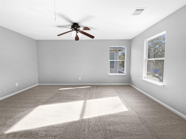 spare room with ceiling fan and carpet