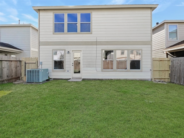 back of house with a yard and cooling unit