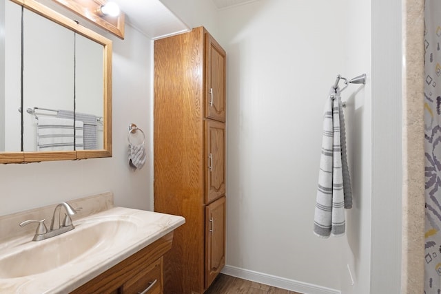 bathroom featuring hardwood / wood-style flooring and vanity