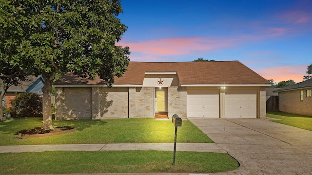 single story home featuring a lawn and a garage