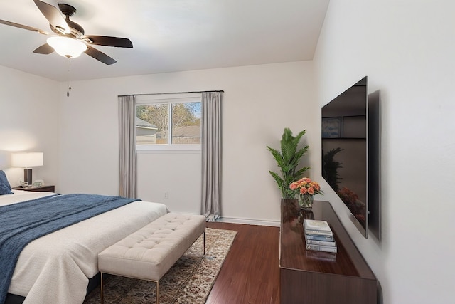 bedroom with ceiling fan and dark hardwood / wood-style flooring