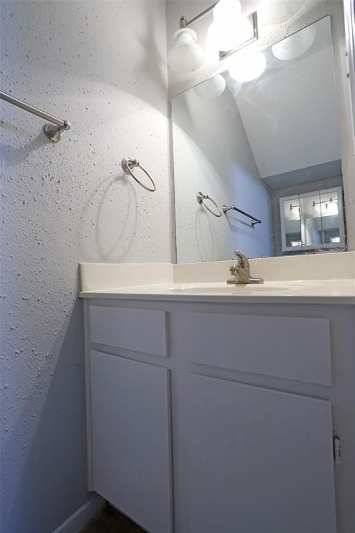 bathroom featuring vanity and vaulted ceiling