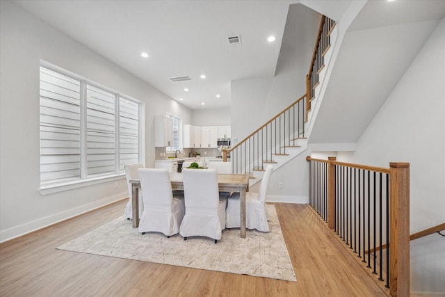 dining space featuring sink and light wood-type flooring