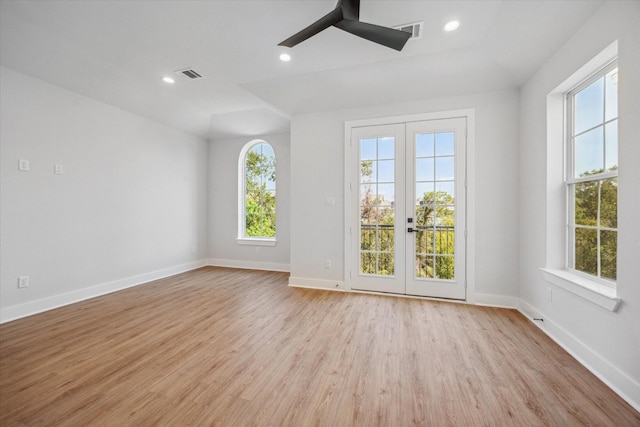 empty room featuring french doors, light hardwood / wood-style flooring, and ceiling fan