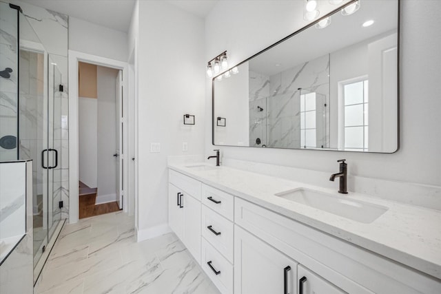 bathroom with vanity and a shower with door