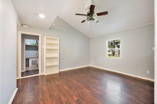 spare room with ceiling fan, built in features, dark wood-type flooring, and vaulted ceiling