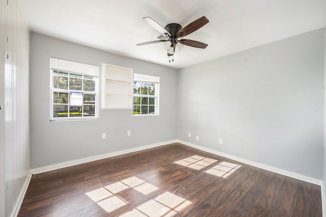 spare room featuring ceiling fan and dark hardwood / wood-style flooring