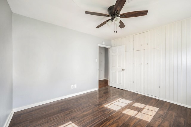 unfurnished bedroom with dark hardwood / wood-style floors and ceiling fan