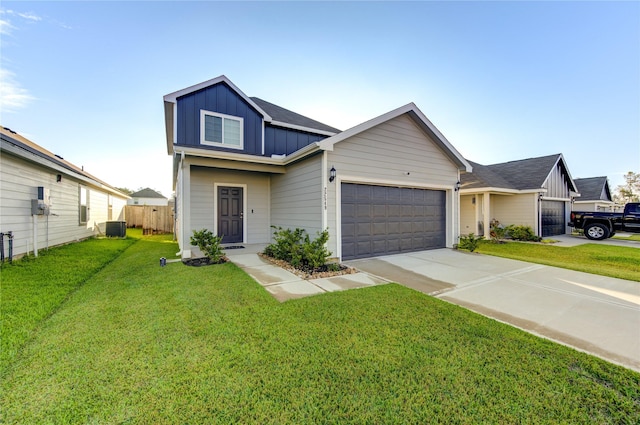 view of front facade with central AC, a front lawn, and a garage