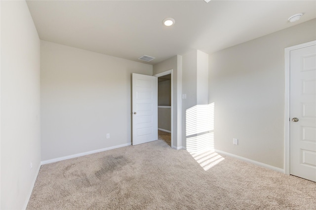 unfurnished room with light colored carpet