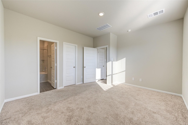 unfurnished bedroom featuring carpet flooring, connected bathroom, a spacious closet, and a closet