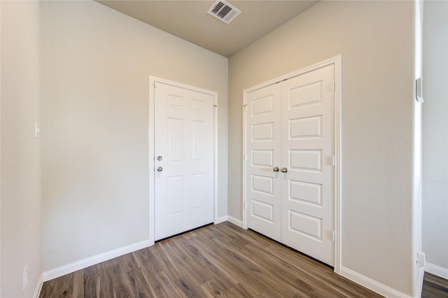 interior space featuring dark hardwood / wood-style floors and a closet