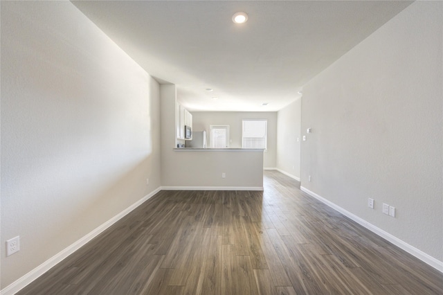 empty room with dark hardwood / wood-style floors