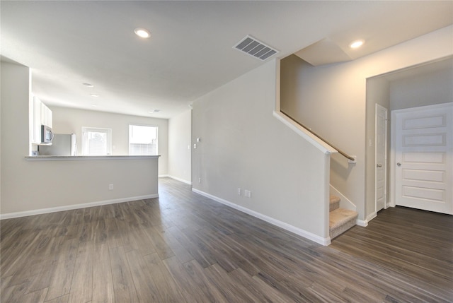 unfurnished living room featuring dark wood-type flooring