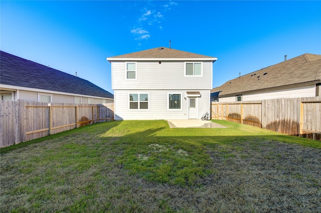 back of property featuring a patio area and a yard