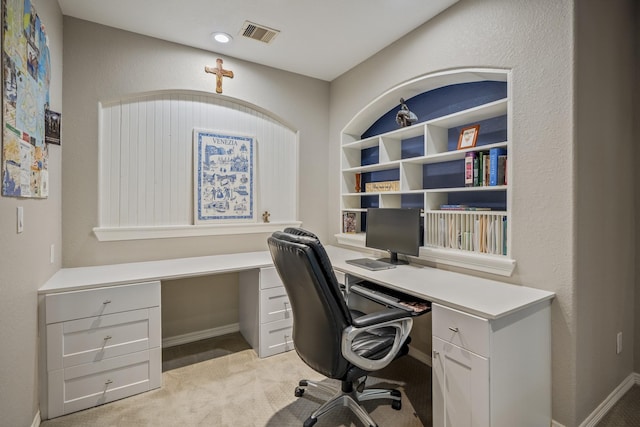 office area with light carpet and built in desk