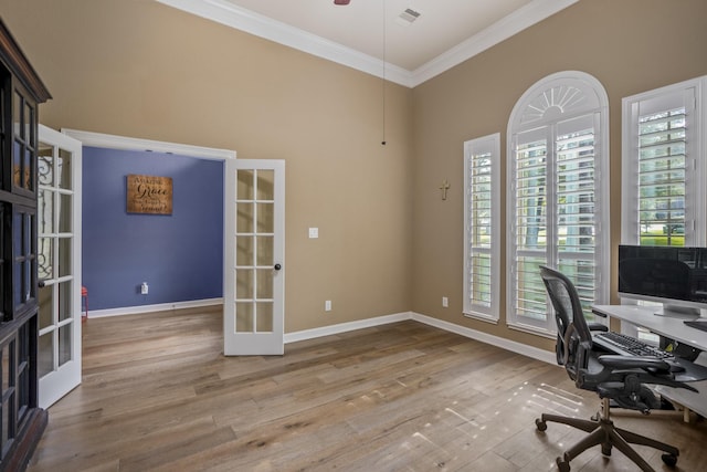 office featuring light hardwood / wood-style floors, ornamental molding, and french doors