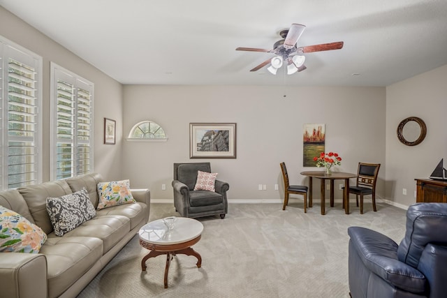 living room with ceiling fan and light colored carpet