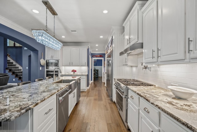 kitchen with built in appliances and white cabinets