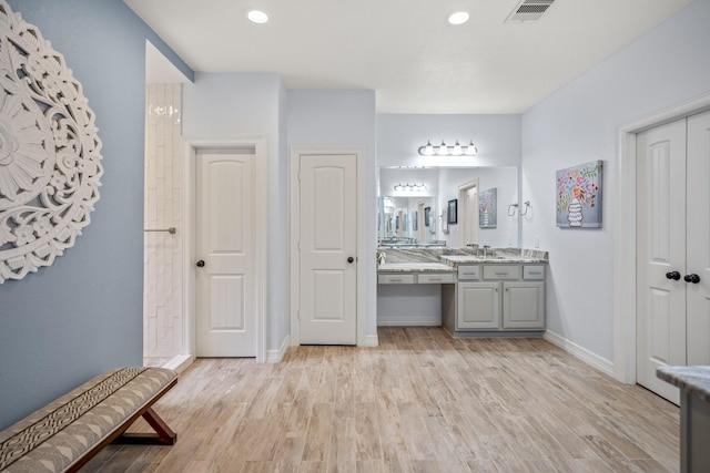 bathroom with hardwood / wood-style flooring and vanity