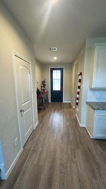 entryway with dark hardwood / wood-style flooring