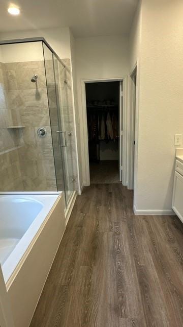 bathroom with independent shower and bath, vanity, and wood-type flooring