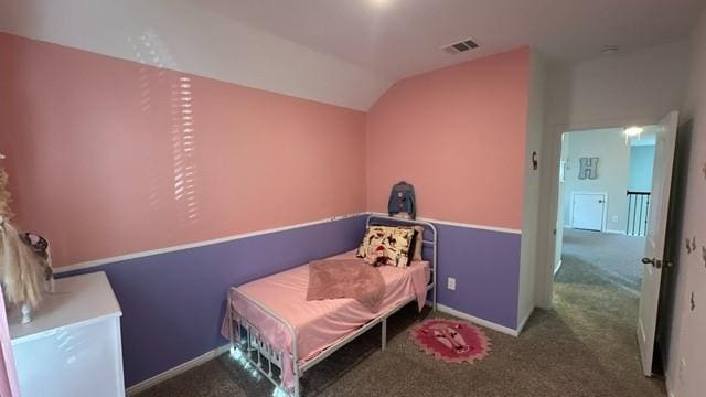 bedroom with dark carpet and vaulted ceiling