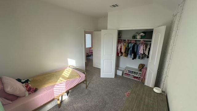 bedroom featuring dark carpet and a closet